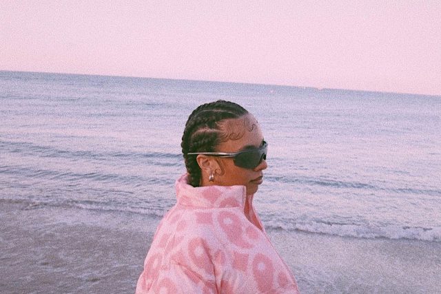 Alexis Philogene posing on the beach
